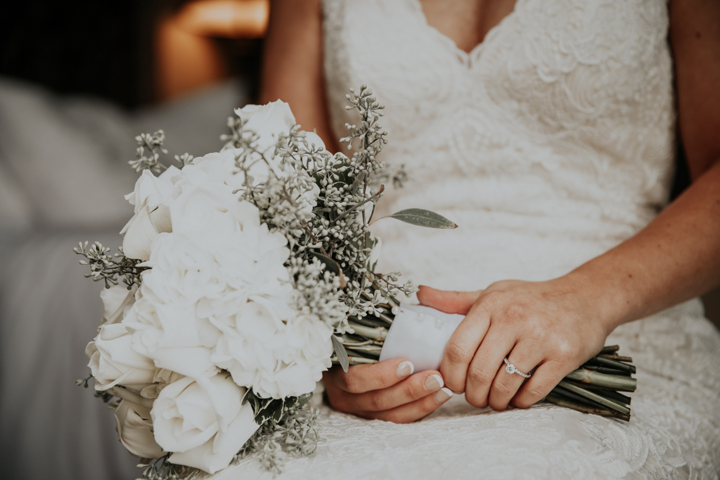 bride sitting down with bouqet